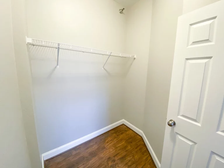 A closet with a wire shelf.