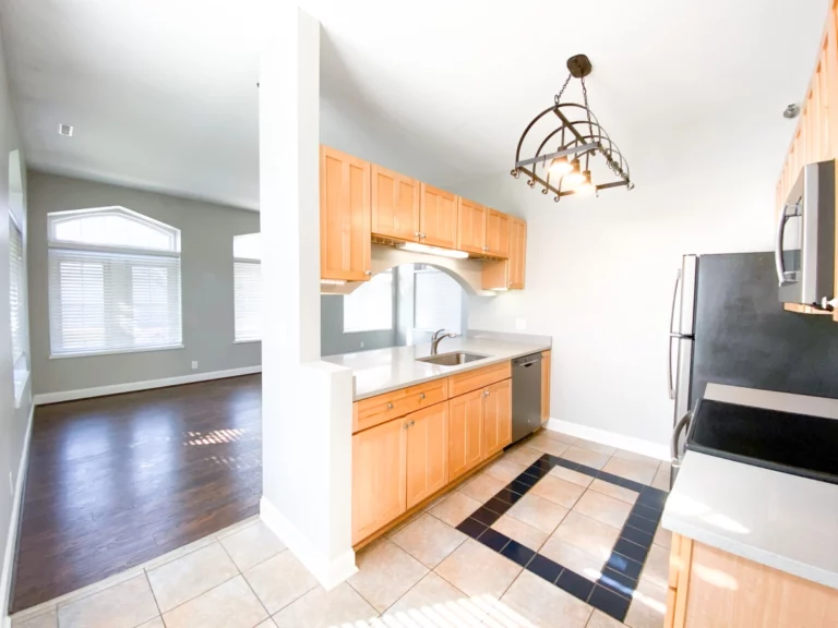 Photograph of kitchen with views into livingroom.